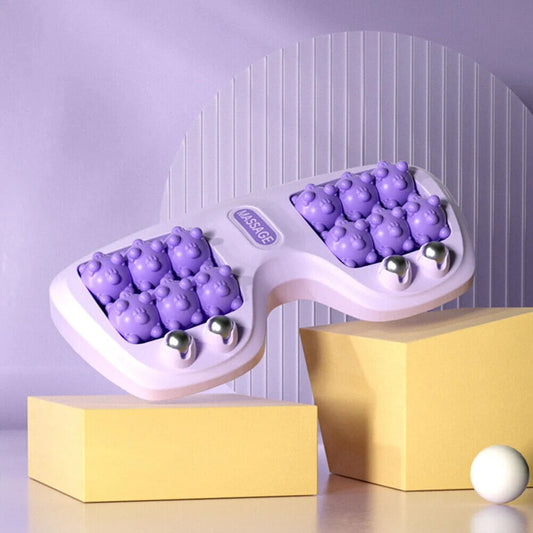 Purple silicone ice cube tray with spherical molds on a yellow block against a purple background