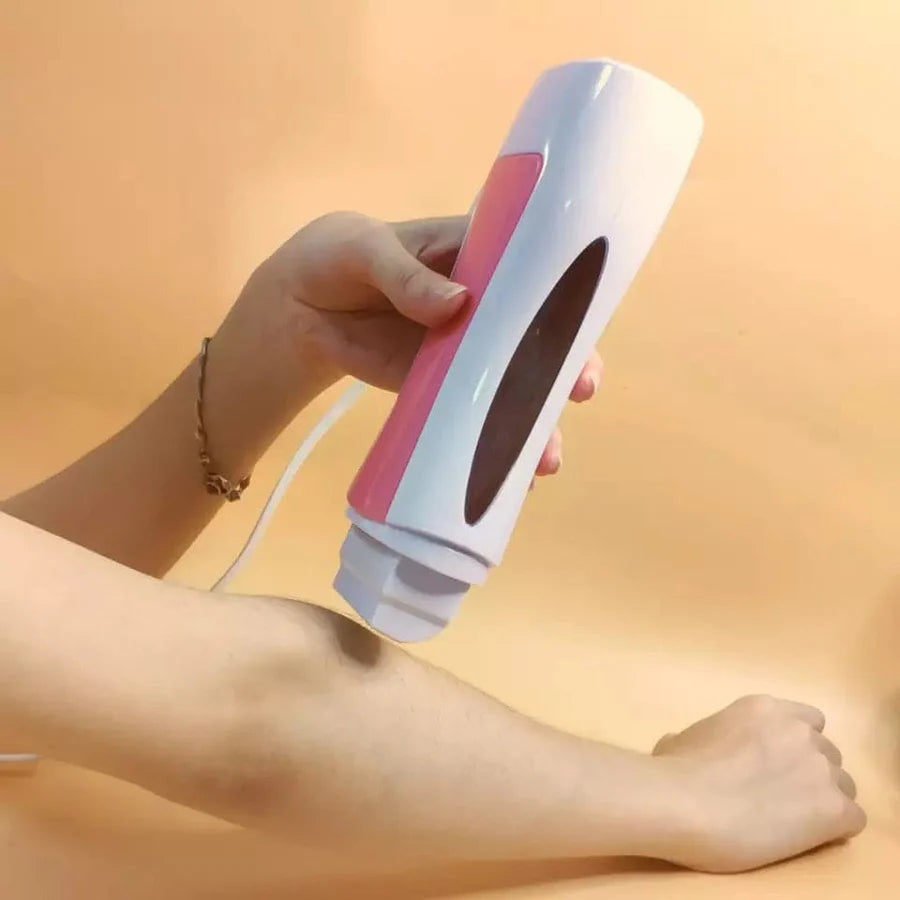 Hand holding a pink and white hair removal device against a leg on a beige background